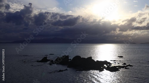 Seaside town of Turgutreis and spectacular sunsets. Bodrum, Turkey. A large rock in the middle of the Aegean Sea