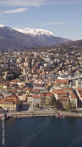 Aerial Panorama of Lugano Cityscape with Alpine Mountains. Vertical video