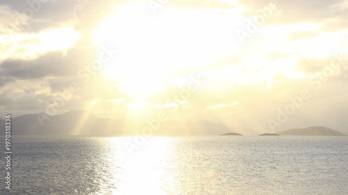 Golden Sunbeams and God Rays Over Aegean Sea with Islands During Sunset Sky Timelapse