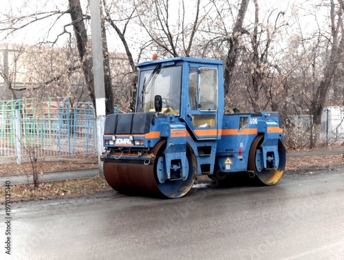 Petropavlovsk, Kazakstan - November 23, 2025: Yellow road roller machine parked on street
