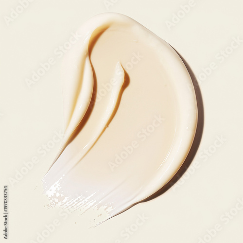 Foto Abstract swirl of beige cosmetic cream with subtle shine on light background