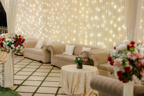 Wallpaper Mural Elegant outdoor lounge area with sofas, decorative string lights, and fresh floral arrangements for a sophisticated event setting Torontodigital.ca