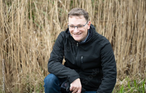 Seated portrait man reeds background Brussels