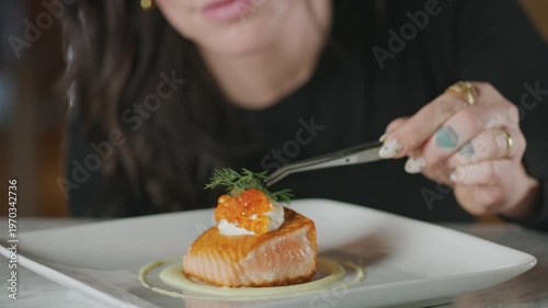 Wallpaper Mural Chef places dill and salmon roe on a plated salmon dish using tweezers. Torontodigital.ca