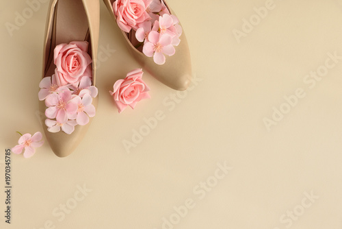 Beige High Heels with Pink Flowers on Cream Background.
