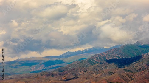 static camera telephoto time lapse of clouds close above mountains in Kyrgyzstan