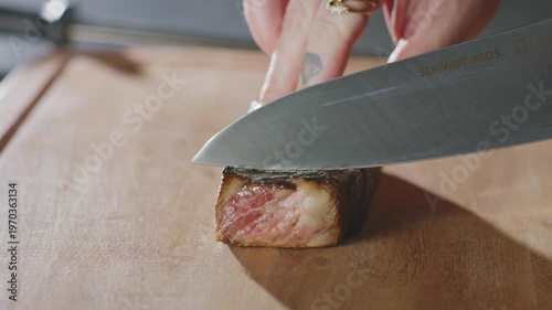 Wallpaper Mural Chef slices a seared steak on a wooden cutting board. Torontodigital.ca