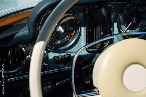 Fotografi Vintage Car Steering Wheel And Dashboard Close-Up With Classic Speedometer And C