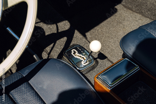 Obraz na plátně Classic Car Interior Closeup With White Ball Gearshift, Blue Leather Seats and W