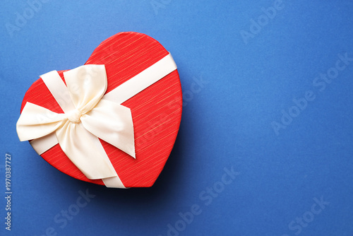 Beautiful heart shaped box on blue background, top view. Space for text