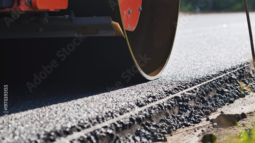 Bilde på lerret Road roller compacting fresh asphalt during new highway construction