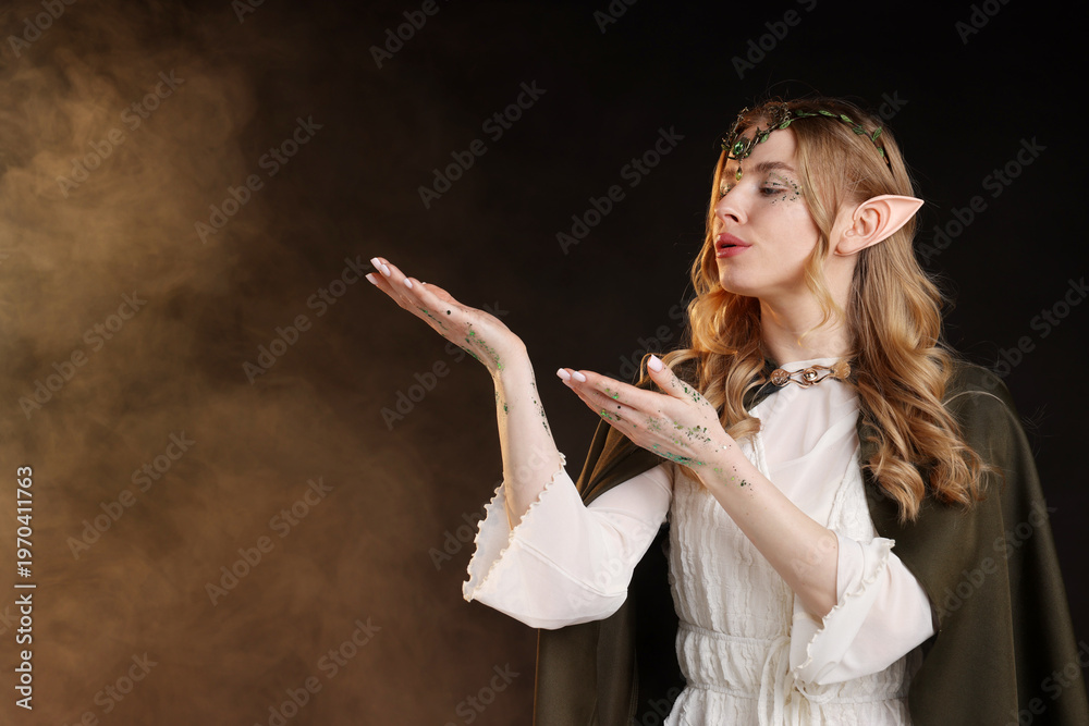 Obraz premium Beautiful elf girl on black background with smoke, space for text
