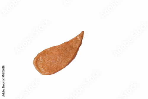Close-up macro texture of shimmering beige cosmetic scrub with fine particles