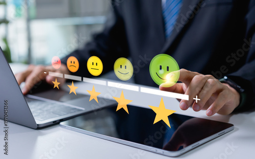 Photography Businessman using tablet selecting maximum star rating with smiley icon, client excellent feedback input, customer satisfaction evaluation and service quality concept