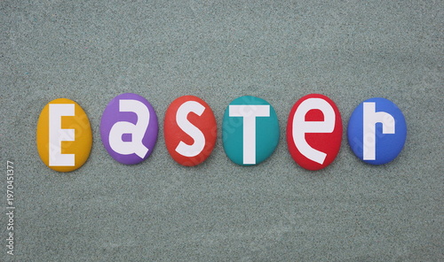 Easter the most important festival in the Christian calendar. It celebrates Jesus rising from the dead, three days after he was executed. Creative text composed with hand painted multi colored stone l