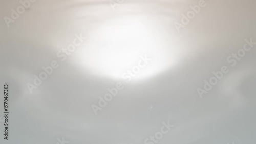 Close-up of Water Droplet Impact Creating Ripples on a Smooth Surface.