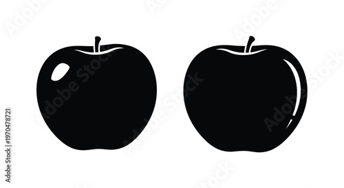 Two black apples displayed side by side a striking silhouette