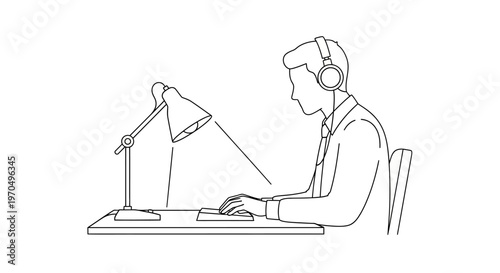 Man wearing headset working on computer.