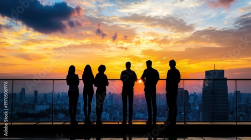 Silhouette of People Contemplating Cityscape at Sunrise from Rooftop View