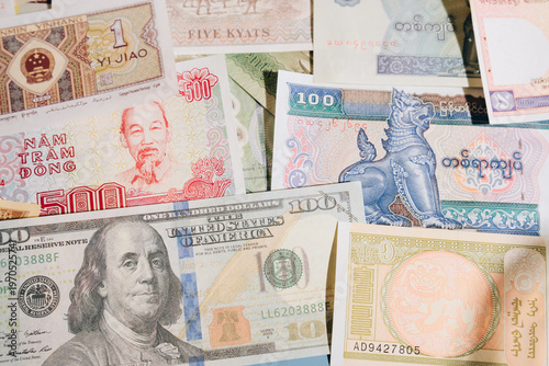 Various international banknote currency collection with different colors and designs, showing diverse cultural and historical elements in close up view