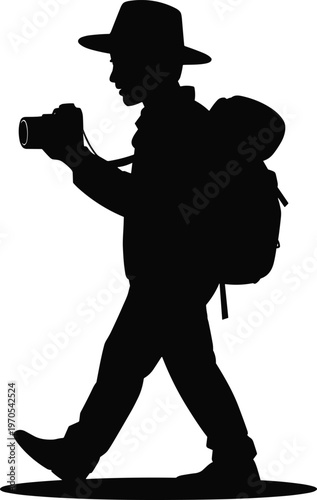 Silhouette of a photographer with a backpack and camera walking