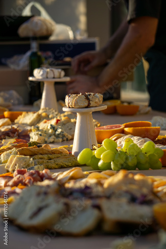 Lavish charcuterie board and grazing table with cheeses, fruits, and cold cuts.