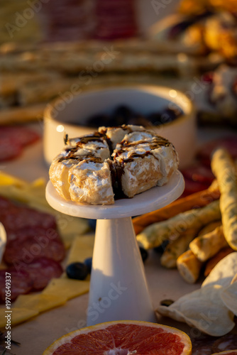 Lavish charcuterie board and grazing table with cheeses, fruits, and cold cuts.