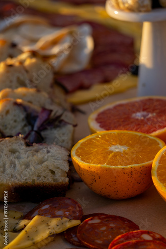 Lavish charcuterie board and grazing table with cheeses, fruits, and cold cuts.