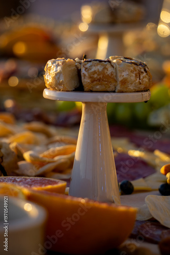 Lavish charcuterie board and grazing table with cheeses, fruits, and cold cuts.