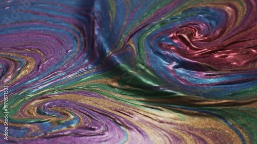 Abstract swirling patterns of metallic paint create a mesmerizing, colorful and textured background