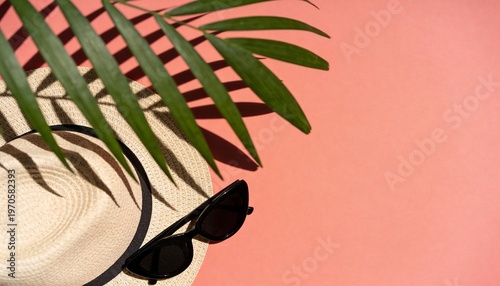 Summer beach essentials flat lay on a pink background with shadow