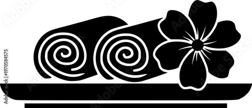 Spa icon with rolled towels and flower on tray in black silhouette
