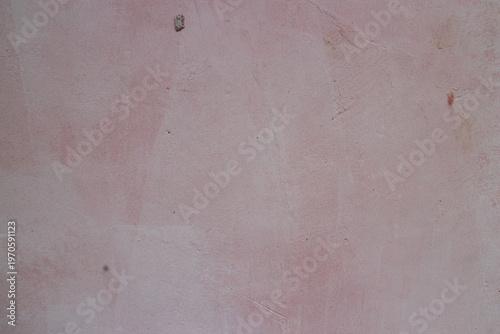 Light pinkish grey painted wall surface texture with subtle grain