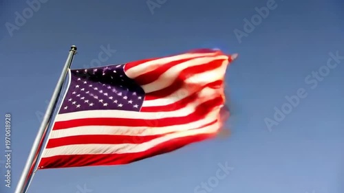 American flag waving proudly against a clear blue sky on a sunny day