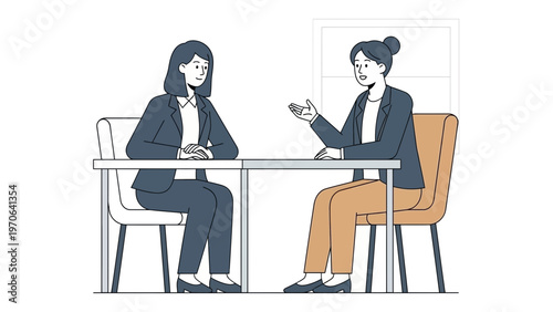 Two women in business attire in a meeting, discussing ideas at a table.