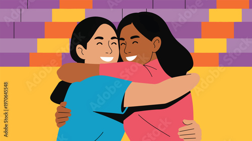 Two women hugging with smiles against a colorful brick wall background, embracing female friendship