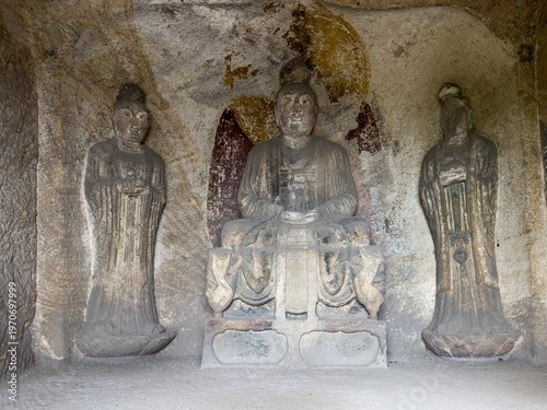 Statues of Prince Jin and two attendants on both sides in Xuanzhen Niche (Niche no. 5) built in Tang Dynasty at Longshan Grottoes on Longshan (Mount Long ), Taiyuan, Shanxi, China. National heritage.