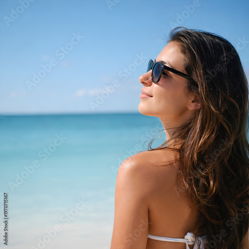 Beach portrait of a woman in sunglasses.