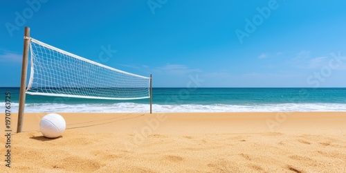 A beach volleyball net and ball set up on golden sand with a calm ocean and clear blue sky in the background.