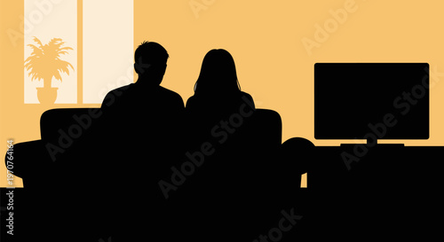 Couple watching tv together in living room with yellow walls and window