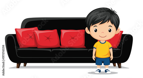 Cute young boy wearing a yellow t-shirt and blue shorts stands smiling in front of a black sofa with red pillows.