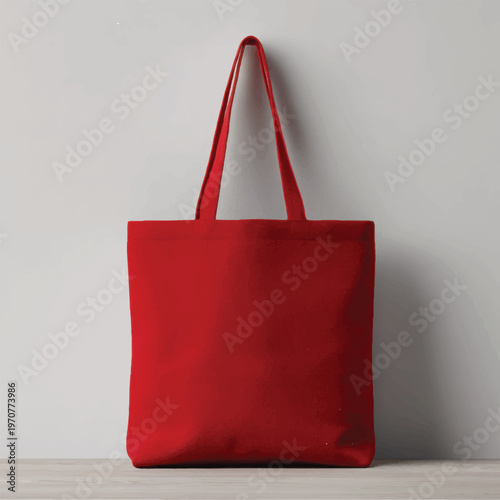 A red tote bag on a gray surface