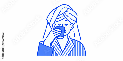 Woman enjoying a warm beverage while wrapped in a towel post shower