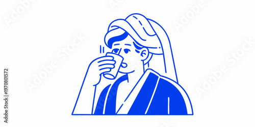 Woman wrapped in a towel enjoys a morning beverage