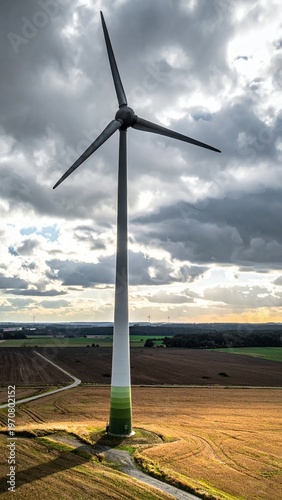 Wind Turbine Generating Clean Energy in Rural Landscape Under Dramatic Sky.