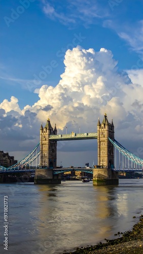 A majestic bridge spans a river under a vibrant blue sky