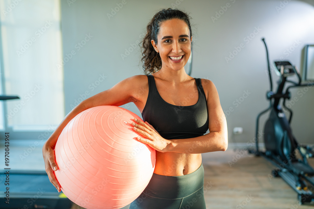 Fototapeta premium Fitness girl lifting exercising with trainer on multistation at gym for arm and shoulders muscles. Fitness exercising in gym.