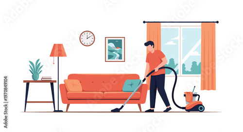 Young man using a canister vacuum cleaner to clean the floor of his modern living room on a bright and sunny day.