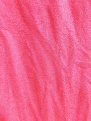 Top view of pink fabric texture background with soft wrinkles and tie dye pattern for fashion design or abstract backdrop.