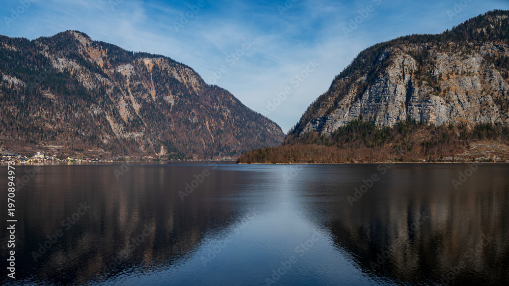 Naklejka premium Alpine lake, river with mountain reflections and dramatic mountains in Austria